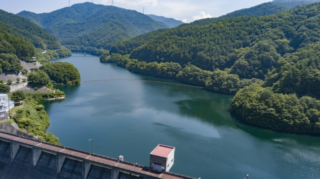 Lake and forested mountains in Minowa, Nagano